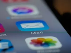 Detailed close-up of an email app icon on a smartphone screen, showcasing neurodiversity-friendly communications.
